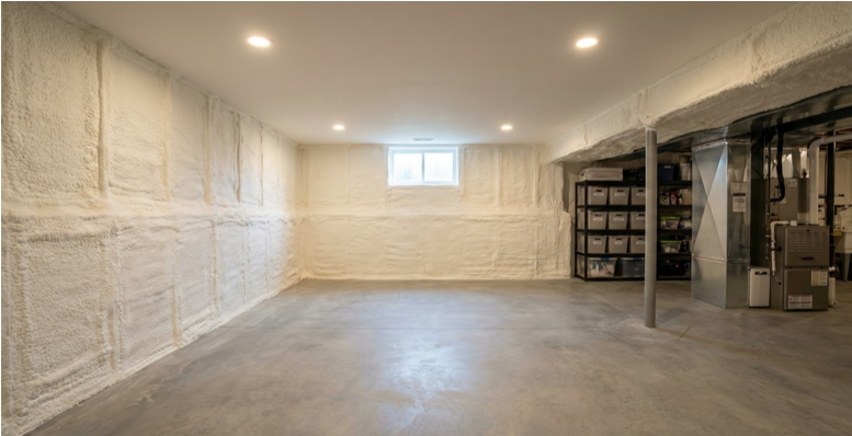 Clean Massachusetts basement with closed-cell spray foam insulation on foundation walls — spray foam insulation basement Massachusetts crawl space moisture control